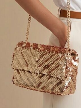Brand new Nicole Miller, New York gold sequin dress purse with long chain